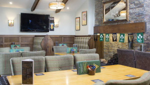 TV and seating area in Oconnors Live Irish Music, Craic agus Ceol & Dining | O’Connors Bar Ballycastle