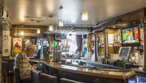 Man sitting at bar Best Pint of Guinness in North Antrim | O’Connors Bar Ballycastle